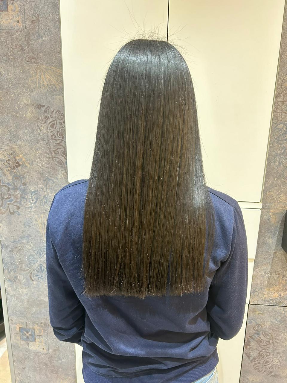 Client after a smooth hair treatment with straight, glossy length
